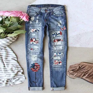 Women's distressed skinny jeans with American flag patches and floral sunflower motifs