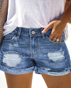 Women's light wash denim shorts with distressed ripped details and frayed raw hem design