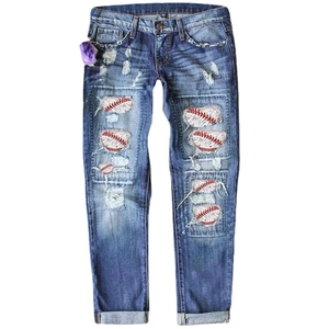 Distressed blue straight leg denim jeans with baseball patches and floral accents