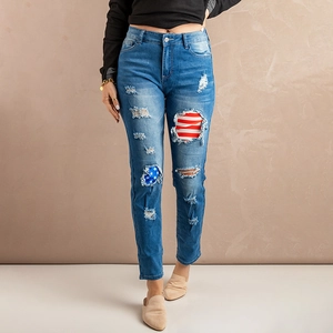 Women's ripped blue jeans with American flag patches and a distressed wash finish