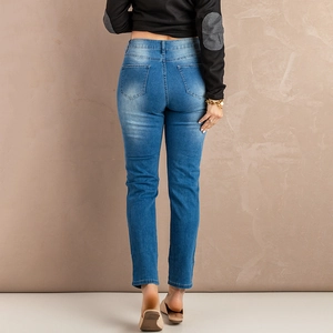 Women's slim fit medium blue washed denim jeans with cat-whisker fading back view