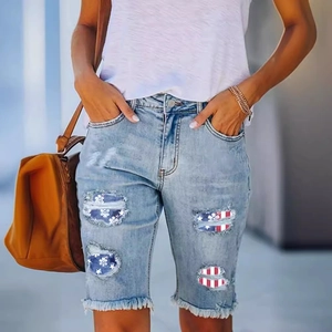 Women's light blue distressed denim shorts with American flag patch and frayed hems