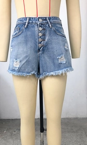 Close-up of high-waisted denim shorts featuring five-button closure and frayed raw hem