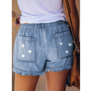 Light blue denim shorts with star print on back pockets and frayed hem for women
