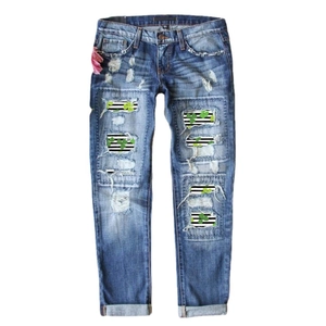 Women's blue distressed jeans with clover patches and striped denim details