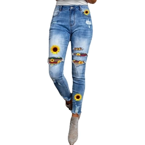 Slim fit high waist ripped jeans with sunflower print and bohemian fabric patches