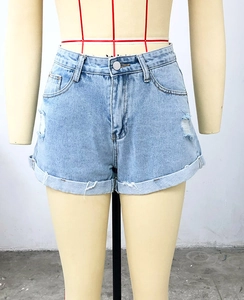Détail du short en jean bleu clair à taille haute avec déchirures et ourlet replié
