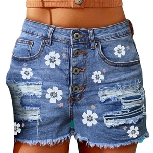 Women's high waist denim shorts with daisy prints, ripped details, and metal buttons