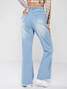 Detail showing high-waisted wide leg jeans with distressed pockets and frayed hem design