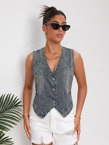 Detail view of a grey washed denim vest with V-neck and three vintage metallic buttons