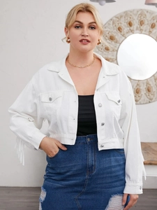 Detail of white cropped denim jacket featuring long fringe tassels on sleeves and back
