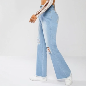 Light blue high waist wide leg ripped jeans with distressed frayed hem and vintage wash