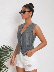 Detailed view of women's grey acid wash denim vest with V-neck and metal button closure