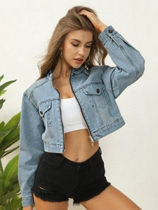 Detail of light blue denim jacket featuring a zipper closure and dual flap pockets