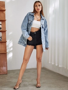 Détail d'une veste en jean bleu clair délavé avec ourlet vieilli et coupe ample décontractée