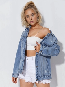 Detail of distressed light blue denim jacket featuring vintage ripped textures and frayed edges