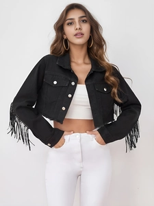Detail of cropped black denim jacket featuring long beaded fringes and silver buttons