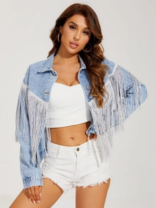 Detailed shot of silver fringe tassels on light blue denim jacket with distressed finish