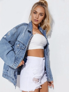Close-up of light blue distressed denim jacket paired with white tank top and shorts