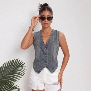 Vintage gray denim vest for women with V-neck and distressed design over white shorts