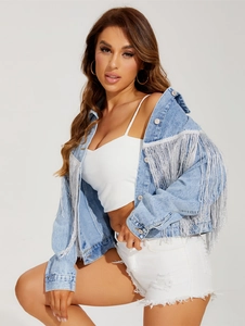 Detail of light blue denim jacket featuring long silver fringe on back and shoulders