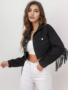 Detailed view of black cropped denim jacket featuring long fringe sleeves and metallic buttons