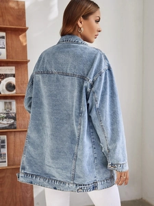 Vue détaillée du dos d'une veste en jean bleu clair oversize avec des coutures soignées