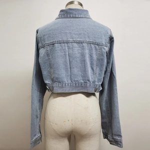 Rear view of light blue cropped denim jacket with adjustable metal waist buckles