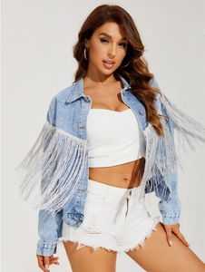 Detail of light blue denim jacket featuring long silver fringe on sleeves and chest