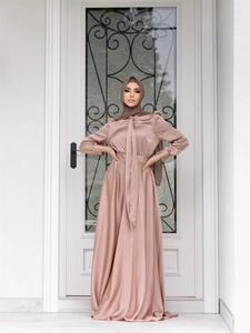 Detail of elegant dusty pink satin maxi dress with long sleeves and matching hijab