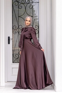 Detail of mocha satin long dress featuring a large bow neckline and smooth silk texture