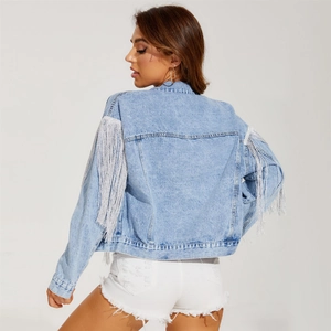 Women's light blue washed denim jacket featuring stylish long silver fringe on the sleeves