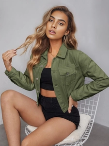 Detail of army green cropped denim jacket with cargo chest pockets and metal buttons