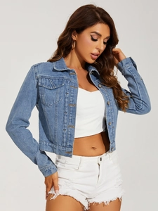 Detail of light blue short denim jacket with metal buttons and classic chest pockets
