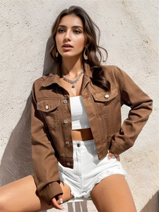 Detail of caramel brown corduroy cropped jacket with metal buttons and flap pockets