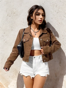 Close-up of cropped brown denim jacket with classic collar and front flap pockets