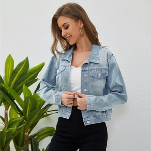 Women's cropped light blue washed denim jacket with chest pockets and metal buttons