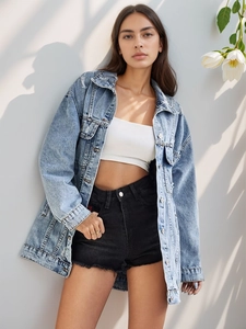 Detail of light blue washed denim jacket with distressed hem and classic button-up collar