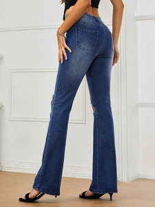 Rear view of distressed high waist flare jeans showing back pockets and knee cutouts
