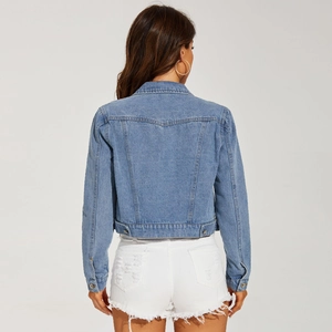 Rear view of women's short light blue denim jacket with white frayed denim shorts