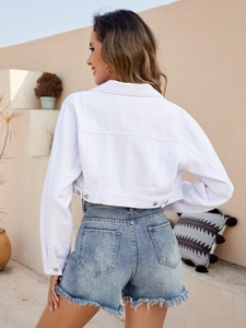 Detailed back view of a white cropped denim jacket with classic collar and metal buttons