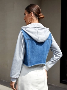 Detail of cropped denim jacket with grey knit sleeves and hood plus frayed hem
