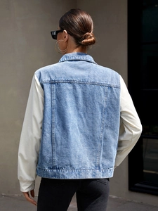 Back view of a loose-fit denim jacket with off-white corduroy sleeves and a classic collar