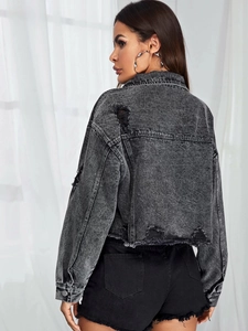 Detailed back view of distressed grey denim jacket featuring frayed hems and ripped details