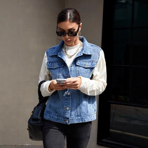 Women's blue denim jacket with beige corduroy sleeves and stylish patchwork design