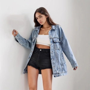 Oversized distressed denim jacket in light blue with ripped details and a classic lapel collar