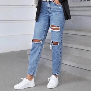 Women's high waist ripped jeans in light blue featuring a casual distressed harlem style cut