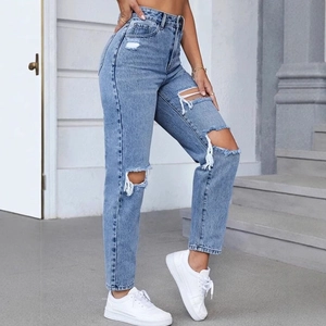 Women's high waist ripped denim jeans in light blue wash with casual distressed details