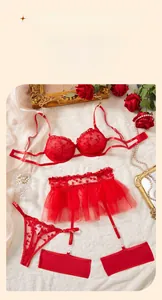 Dettaglio completo intimo rosso con ricamo a cuore su reggiseno in pizzo e gonna in rete