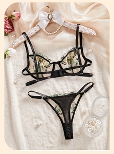 Exquisite black mesh lingerie set with butterfly embroidery on fluffy background